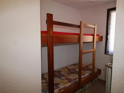 a bunk bed in a room with a ladder at Studio aux Carroz 4 pers, balcon, proche commerces et pistes - FR-1-572-254 in Arâches-la-Frasse