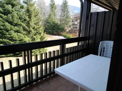 a white table on a balcony with a view at Studio aux Carroz 4 pers, balcon, proche commerces et pistes - FR-1-572-254 in Arâches-la-Frasse