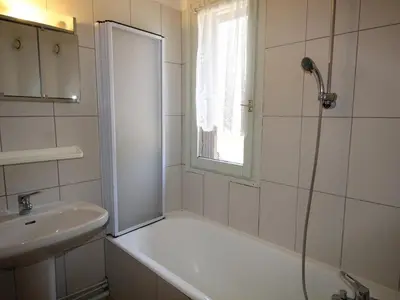 a white bathroom with a shower and a sink at Studio aux Carroz 4 pers, balcon, proche commerces et pistes - FR-1-572-254 in Arâches-la-Frasse