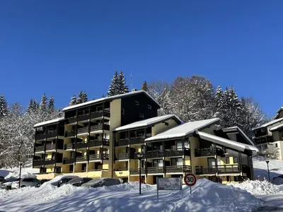 a apartment building in the snow with snow covered at Studio aux Carroz 4 pers, balcon, proche commerces et pistes - FR-1-572-254 in Arâches-la-Frasse