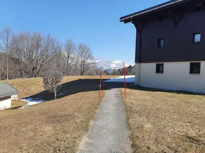 a path in front of a house with red poles at Mountain RoomChaleureux - Accueillant & Convivial in Demi-Quartier