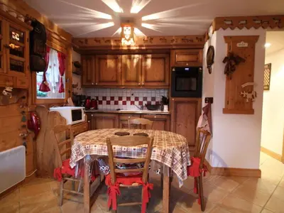 a kitchen with a table and chairs in a room at Appartement 3 pièces pour 6 pers, bien équipé, face au spa et ski bus, proche pistes et commerces - FR-1-572-10 in Arâches-la-Frasse