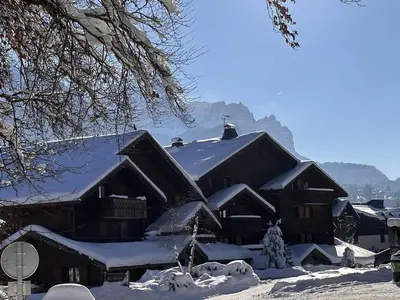 a large building covered in snow with snow at 3 pièces, 6 pers, animaux admis, parking, vue sur piscine - FR-1-572-5 in Arâches-la-Frasse