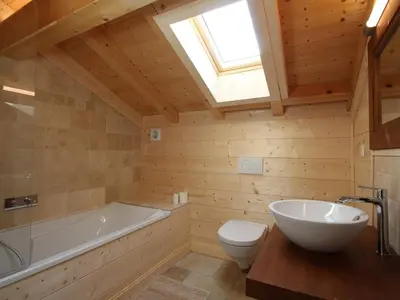 a bathroom with a tub and a toilet and a sink at Chalet cosy 12 pers. à 1km des pistes, 5 ch., WiFi, cheminée, abri voiture - FR-1-572-30 in Arâches-la-Frasse