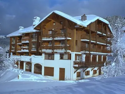 a large building with snow on top of it at Charmant studio duplex rénové, 4/5 pers, garage, proche centre, pistes et commerces. - FR-1-572-60 in Arâches-la-Frasse
