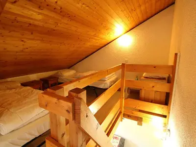 a room with two bunk beds and a wooden ceiling at Charmant studio duplex rénové, 4/5 pers, garage, proche centre, pistes et commerces. - FR-1-572-60 in Arâches-la-Frasse