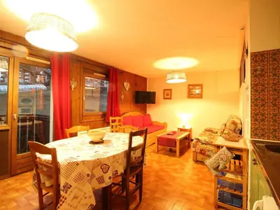 a living room with a table and a couch at Studio pour 6 pers avec sdd rénovée et parking, sur les pistes - FR-1-572-80 in Arâches-la-Frasse