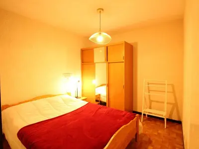 a bedroom with a bed with a red blanket at Studio pour 6 pers avec sdd rénovée et parking, sur les pistes - FR-1-572-80 in Arâches-la-Frasse