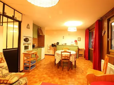 a kitchen and dining room with a table in a room at Studio pour 6 pers avec sdd rénovée et parking, sur les pistes - FR-1-572-80 in Arâches-la-Frasse