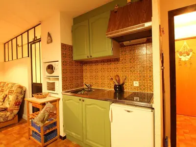 a kitchen with green cabinets and a sink at Studio pour 6 pers avec sdd rénovée et parking, sur les pistes - FR-1-572-80 in Arâches-la-Frasse