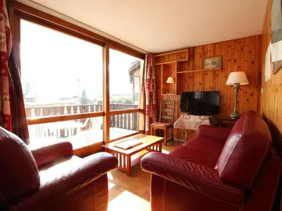 a living room with a red couch and a large window at Spacieux 3 pièces au centre d'Arâches-la-Frasse, 6 pers., proche pistes et commerces - FR-1-572-69 in Arâches-la-Frasse