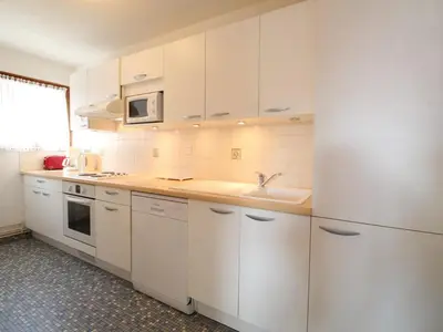 a kitchen with white cabinets and a sink at Spacieux 3 pièces au centre d'Arâches-la-Frasse, 6 pers., proche pistes et commerces - FR-1-572-69 in Arâches-la-Frasse