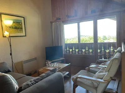 a living room with two couches and a television at Duplex lumineux 3 pièces, 7 pers, 3 balcons, proche pistes et commerces, parking, ski bus - FR-1-572-72 in Arâches-la-Frasse