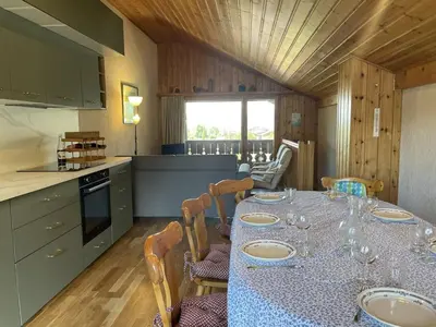 a kitchen with a table with plates and glasses on it at Duplex lumineux 3 pièces, 7 pers, 3 balcons, proche pistes et commerces, parking, ski bus - FR-1-572-72 in Arâches-la-Frasse