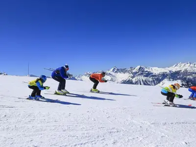 a group of people skiing down a snow covered slope at Duplex 6 pers sur pistes débutants avec parking - Les Carroz d'Arâches - FR-1-572-74 in Arâches-la-Frasse