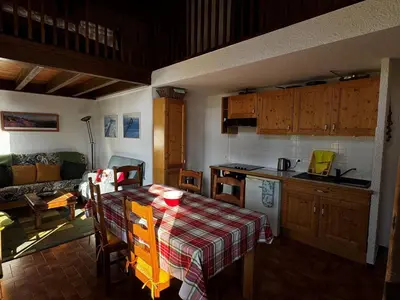a kitchen with a table with a checked table cloth on it at Duplex 6 pers sur pistes débutants avec parking - Les Carroz d'Arâches - FR-1-572-74 in Arâches-la-Frasse