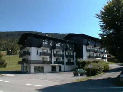 a building with a car parked in a parking lot at Duplex 6 pers sur pistes débutants avec parking - Les Carroz d'Arâches - FR-1-572-74 in Arâches-la-Frasse