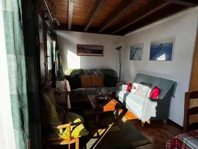 a living room with a couch and a table at Duplex 6 pers sur pistes débutants avec parking - Les Carroz d'Arâches - FR-1-572-74 in Arâches-la-Frasse