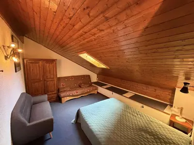 a room with a bed and a chair in a room at Duplex moderne 3 pièces proche des pistes, 8 pers. - FR-1-572-71 in Arâches-la-Frasse