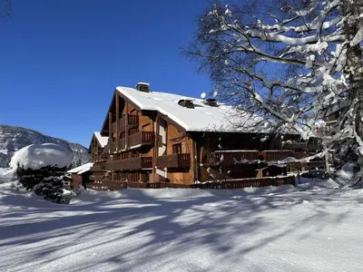 a large wooden building in the snow with snow at Duplex moderne 3 pièces proche des pistes, 8 pers. - FR-1-572-71 in Arâches-la-Frasse