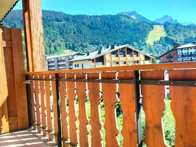 a wooden balcony with a view of a mountain at Duplex moderne 3 pièces proche des pistes, 8 pers. - FR-1-572-71 in Arâches-la-Frasse