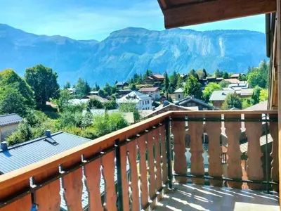 a balcony with a view of a town and mountains at Duplex moderne 3 pièces proche des pistes, 8 pers. - FR-1-572-71 in Arâches-la-Frasse