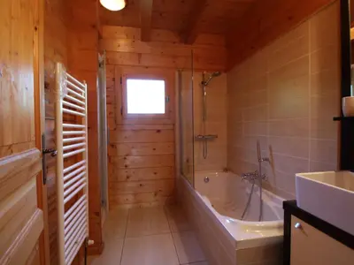 a bathroom with a bath tub and a sink at Chalet typique 10 pers, Arâches-la-Frasse - FR-1-572-27 in Arâches-la-Frasse