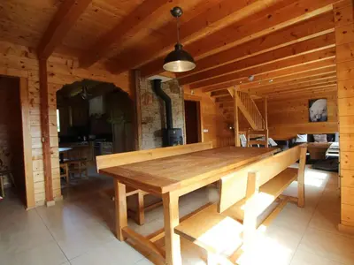 a wooden dining room with a large wooden table at Chalet typique 10 pers, Arâches-la-Frasse - FR-1-572-27 in Arâches-la-Frasse