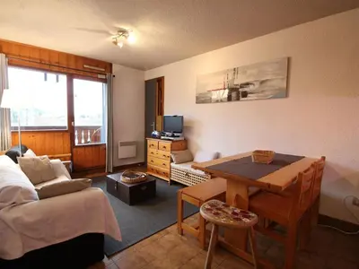a living room with a table and a living room with a couch at 3 pièces familiales, 4 pers, garage, centre des Carroz - FR-1-572-75 in Arâches-la-Frasse