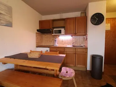 a kitchen with a wooden table and a dining room at 3 pièces familiales, 4 pers, garage, centre des Carroz - FR-1-572-75 in Arâches-la-Frasse
