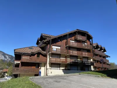 a apartment building with balconies and a parking lot at 3 pièces familiales, 4 pers, garage, centre des Carroz - FR-1-572-75 in Arâches-la-Frasse