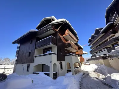 a building in the snow with snow around it at 3 pièces familiales, 4 pers, garage, centre des Carroz - FR-1-572-75 in Arâches-la-Frasse