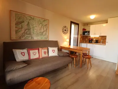a living room with a couch and a table at Appartement 2 pièces 5 pers, pied des pistes, garage privé, proche village et commerces - FR-1-572-57 in Arâches-la-Frasse