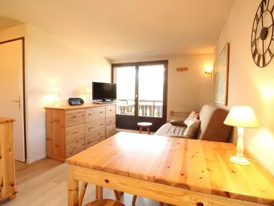 a living room with a wooden table and a couch at Appartement 2 pièces 5 pers, pied des pistes, garage privé, proche village et commerces - FR-1-572-57 in Arâches-la-Frasse
