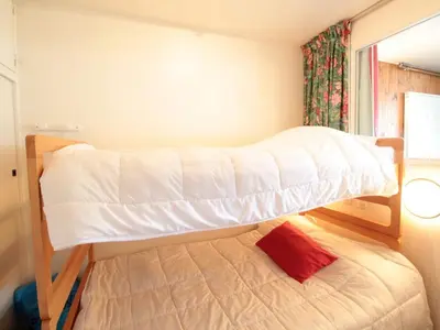 two bunk beds in a small room with a bed at Studio 4 pers, cabine, Les Carroz, proche pistes - FR-1-572-95 in Arâches-la-Frasse