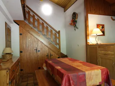 a bedroom with a bed and a wooden staircase at Appartement cosy 5 pers., pied des pistes, balcon est, proche commerces, parking & services - FR-1-572-94 in Arâches-la-Frasse