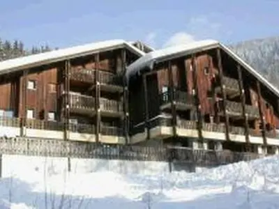 a train sitting on a bridge in the snow at Appartement cosy 5 pers., pied des pistes, balcon est, proche commerces, parking & services - FR-1-572-94 in Arâches-la-Frasse