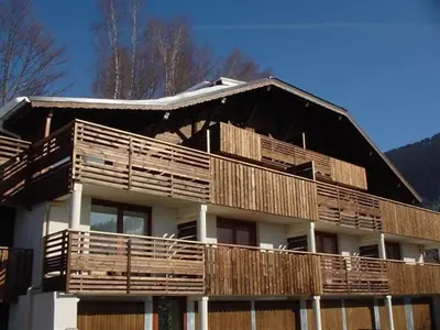 a large house with wooden balconies on top of it at 3 Pièces 6 Pers, Proche Pistes & Centre, Balcon Sud, Parking, Non-Fumeur - FR-1-572-158 in Arâches-la-Frasse