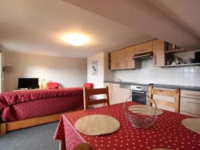 a small kitchen with a table and a bed in a room at 3 Pièces 6 Pers, Proche Pistes & Centre, Balcon Sud, Parking, Non-Fumeur - FR-1-572-158 in Arâches-la-Frasse
