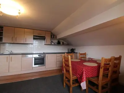 a kitchen with a table with a red table cloth at 3 Pièces 6 Pers, Proche Pistes & Centre, Balcon Sud, Parking, Non-Fumeur - FR-1-572-158 in Arâches-la-Frasse