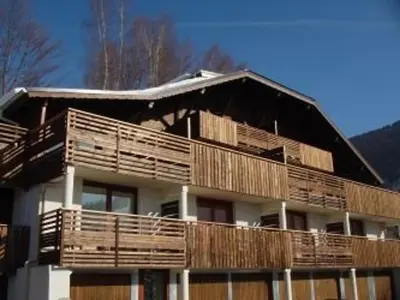 a large house with wooden balconies on top of it at 3 Pièces 6 Pers, Proche Pistes & Centre, Balcon Sud, Parking, Non-Fumeur - FR-1-572-158 in Arâches-la-Frasse