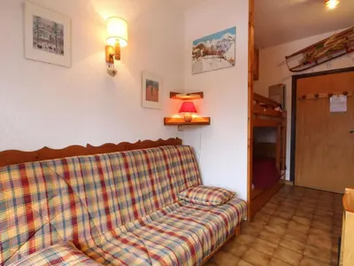 a couch sitting in a living room with a lamp at Studio pour 4 personnes avec balcon et équipements, au pied des pistes et à 550m du village - FR-1-572-157 in Arâches-la-Frasse