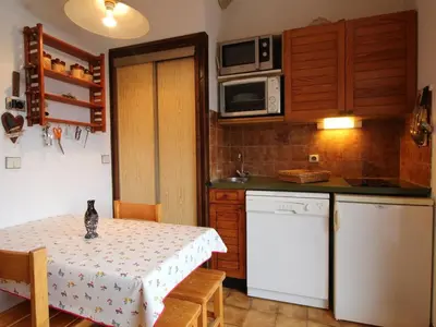 a small kitchen with a table with a cat sitting on it at Studio pour 4 personnes avec balcon et équipements, au pied des pistes et à 550m du village - FR-1-572-157 in Arâches-la-Frasse