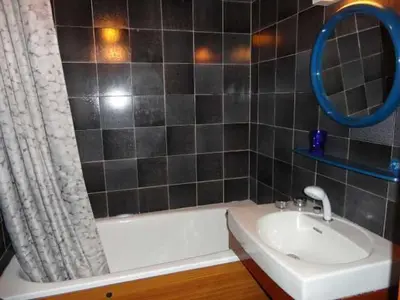 a bathroom with a tub and a sink and a mirror at Studio 4 pers. avec lave-linge, balcon et accès direct aux pistes - Proche centre des Carroz - FR-1-572-176 in Arâches-la-Frasse