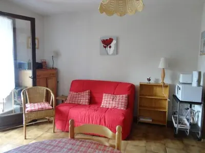 a living room with a red couch and a chair at Studio 4 pers. avec lave-linge, balcon et accès direct aux pistes - Proche centre des Carroz - FR-1-572-176 in Arâches-la-Frasse