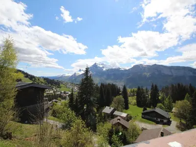 a view of a village with mountains in the background at Chalet 5 ch, 11 pers, terrasse sud, Les Carroz - FR-1-572-115 in Arâches-la-Frasse