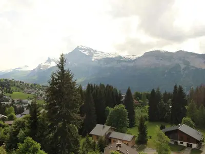 a small town in a valley with snow capped mountains at Chalet 5 ch, 11 pers, terrasse sud, Les Carroz - FR-1-572-115 in Arâches-la-Frasse