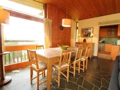 a dining room with a wooden table and chairs at Chalet 5 ch, 11 pers, terrasse sud, Les Carroz - FR-1-572-115 in Arâches-la-Frasse