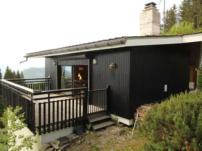a black house with a balcony and a chimney at Chalet 5 ch, 11 pers, terrasse sud, Les Carroz - FR-1-572-115 in Arâches-la-Frasse