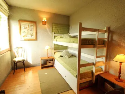 a room with two bunk beds and a lamp at Chalet 5 ch, 11 pers, terrasse sud, Les Carroz - FR-1-572-115 in Arâches-la-Frasse